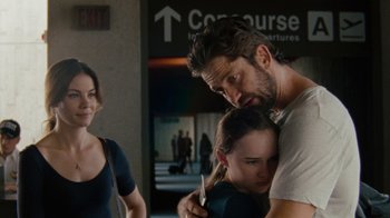 Movie still from “Machine Gun Preacher” (2011), directed by Marc Forster – A man and a woman hug in front of a building; Medium shot, Over the shoulder angle