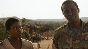Movie still from “Machine Gun Preacher” (2011), directed by Marc Forster – Two men standing next to each other on a dirt field; Close Up shot, Over the shoulder angle