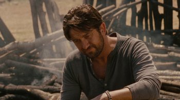 Movie still from “Machine Gun Preacher” (2011), directed by Marc Forster – A person sitting in a chair; Close Up shot, Over the shoulder angle