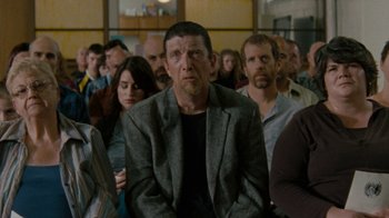 Movie still from “Machine Gun Preacher” (2011), directed by Marc Forster – A group of people sitting in a room; Medium shot, Over the shoulder angle