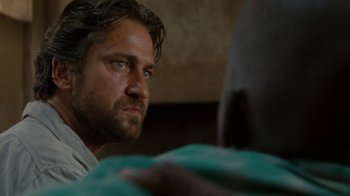 Movie still from “Machine Gun Preacher” (2011), directed by Marc Forster – A person sitting in front of a person; Close Up shot, Over the shoulder angle