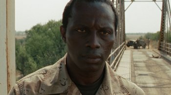 Movie still from “Machine Gun Preacher” (2011), directed by Marc Forster – A person wearing a military uniform; Close Up shot, Low angle