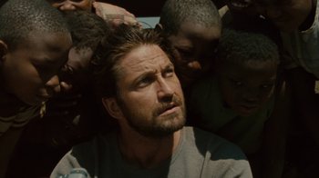 Movie still from “Machine Gun Preacher” (2011), directed by Marc Forster – A person in a crowd of people; Close Up shot, High angle
