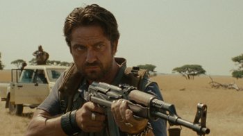 Movie still from “Machine Gun Preacher” (2011), directed by Marc Forster – A person holding a gun; Close Up shot, Low angle