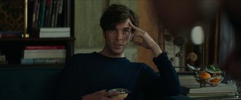 Movie still from “Madame” (2017), directed by Amanda Sthers – A young man holding a drink while standing in front of a mirror; Close Up shot, Over the shoulder angle