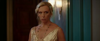 Movie still from “Madame” (2017), directed by Amanda Sthers – A woman in a gold dress and a necklace; Close Up shot, Over the shoulder angle
