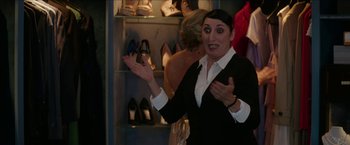 Movie still from “Madame” (2017), directed by Amanda Sthers – A woman standing in front of a display of shoes; Medium shot, Over the shoulder angle