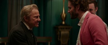 Movie still from “Madame” (2017), directed by Amanda Sthers – Two men talking to each other in a green room; Close Up shot, Over the shoulder angle