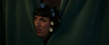 Movie still from “Madame” (2017), directed by Amanda Sthers – A woman with hair curlers on her head; Close Up shot, Over the shoulder angle