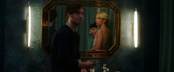 Movie still from “Madame” (2017), directed by Amanda Sthers – A man standing in front of a bathroom mirror; Medium shot, Over the shoulder angle