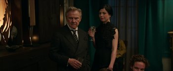 Movie still from “Madame” (2017), directed by Amanda Sthers – An older man and a young woman holding wine glasses; Medium shot, Over the shoulder angle