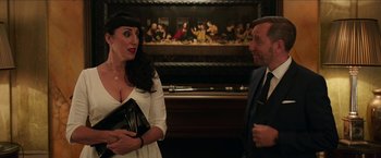 Movie still from “Madame” (2017), directed by Amanda Sthers – A man and a woman standing next to each other in a room; Medium shot, Over the shoulder angle