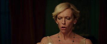 Movie still from “Madame” (2017), directed by Amanda Sthers – A blonde woman with short blonde hair wearing a white dress; Close Up shot, Over the shoulder angle