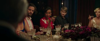 Movie still from “Madame” (2017), directed by Amanda Sthers – A group of people sitting at a dinner table with wine glasses; Medium shot, Over the shoulder angle