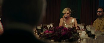 Movie still from “Madame” (2017), directed by Amanda Sthers – A woman sitting at a dinner table drinking wine; Medium shot, Over the shoulder angle