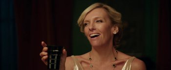Movie still from “Madame” (2017), directed by Amanda Sthers – A woman holding a cup and smiling at the camera; Close Up shot, Over the shoulder angle