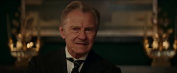 Movie still from “Madame” (2017), directed by Amanda Sthers – An older man wearing a suit and tie; Close Up shot, Low angle