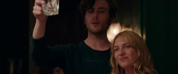 Movie still from “Madame” (2017), directed by Amanda Sthers – A man and a woman posing for a picture in front of lights; Close Up shot, Low angle