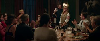 Movie still from “Madame” (2017), directed by Amanda Sthers – A group of people sitting around a dinner table; Medium shot, Over the shoulder angle