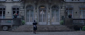 Movie still from “Madame” (2017), directed by Amanda Sthers – A woman standing in front of an old building; Wide shot, Low angle