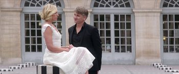 Movie still from “Madame” (2017), directed by Amanda Sthers – A man and a woman standing next to each other; Wide shot, Low angle