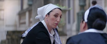 Movie still from “Madame” (2017), directed by Amanda Sthers – A woman wearing a head scarf and a jacket; Close Up shot, Over the shoulder angle