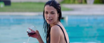 Movie still from “Madame” (2017), directed by Amanda Sthers – A woman holding a glass of red wine in front of a swimming pool; Close Up shot, Over the shoulder angle