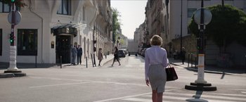 Movie still from “Madame” (2017), directed by Amanda Sthers – A woman is walking down the street holding a purse; Wide shot, Over the shoulder angle