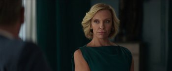 Movie still from “Madame” (2017), directed by Amanda Sthers – A woman with blonde hair wearing a green dress; Close Up shot, Over the shoulder angle