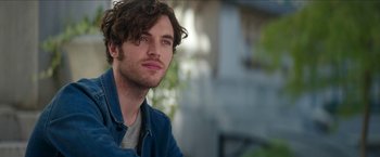 Movie still from “Madame” (2017), directed by Amanda Sthers – A person wearing a blue jacket; Close Up shot, Over the shoulder angle