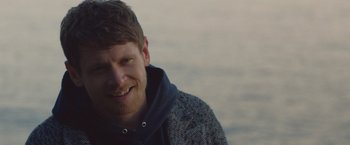 Movie still from “Little Fish” (2020), directed by Chad Hartigan – A person wearing a sweater; Close Up shot, Over the shoulder angle