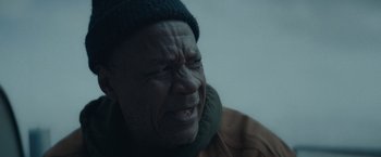 Movie still from “Little Fish” (2020), directed by Chad Hartigan – An older man with a hat and a jacket on; Close Up shot, Over the shoulder angle