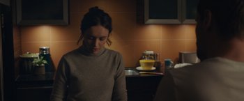 Movie still from “Little Fish” (2020), directed by Chad Hartigan – A woman sitting in front of an open laptop computer; Medium shot, Over the shoulder angle