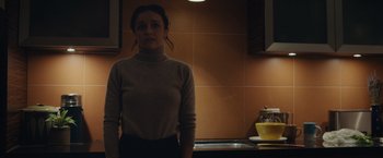 Movie still from “Little Fish” (2020), directed by Chad Hartigan – A woman standing in a kitchen in front of a sink; Medium shot, Low angle