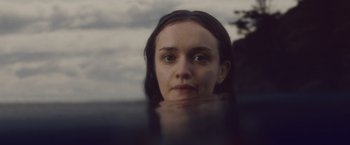 Movie still from “Little Fish” (2020), directed by Chad Hartigan – A woman is looking out of the water at the beach; Close Up shot, High angle