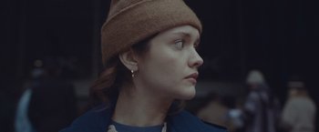 Movie still from “Little Fish” (2020), directed by Chad Hartigan – A person wearing a hat and looking to the side; Close Up shot, Low angle