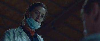 Movie still from “Little Fish” (2020), directed by Chad Hartigan – A woman wearing a face mask in a building; Close Up shot, Low angle