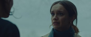 Movie still from “Little Fish” (2020), directed by Chad Hartigan – A person wearing a scarf; Close Up shot, Over the shoulder angle