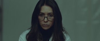 Movie still from “Little Fish” (2020), directed by Chad Hartigan – A person wearing glasses and a lab coat; Close Up shot, Low angle
