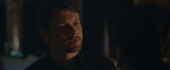 Movie still from “Little Fish” (2020), directed by Chad Hartigan – A person wearing a black shirt; Close Up shot, Over the shoulder angle