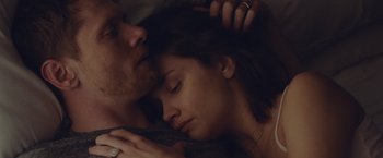Movie still from “Little Fish” (2020), directed by Chad Hartigan – A man and a woman laying in a bed together; Close Up shot, Overhead angle