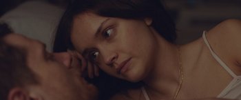 Movie still from “Little Fish” (2020), directed by Chad Hartigan – A person laying down with her head resting on her hand; Close Up shot, Over the shoulder angle