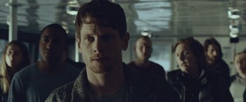 Movie still from “Little Fish” (2020), directed by Chad Hartigan – A man sitting next to another man on a bus; Close Up shot, Over the shoulder angle