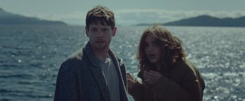 Movie still from “Little Fish” (2020), directed by Chad Hartigan – A man and a woman standing next to a body of water; Medium shot, Over the shoulder angle