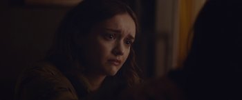 Movie still from “Little Fish” (2020), directed by Chad Hartigan – A young woman looking sad while sitting in a chair; Close Up shot, Over the shoulder angle