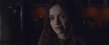 Movie still from “Little Fish” (2020), directed by Chad Hartigan – A person sitting in a dark room; Close Up shot, Over the shoulder angle