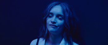 Movie still from “Little Fish” (2020), directed by Chad Hartigan – A woman with long blue hair is smiling; Close Up shot, High angle