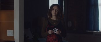 Movie still from “Little Fish” (2020), directed by Chad Hartigan – A young woman holding a photo of herself; Medium shot, Over the shoulder angle