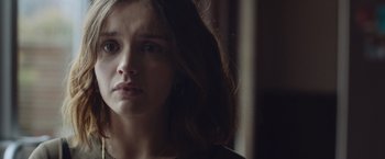 Movie still from “Little Fish” (2020), directed by Chad Hartigan – A person with long brown hair; Close Up shot, Over the shoulder angle