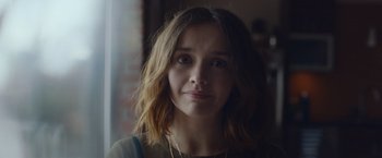 Movie still from “Little Fish” (2020), directed by Chad Hartigan – A person wearing a necklace; Close Up shot, Over the shoulder angle